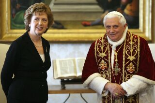 FILE - In this March 23, 2007 file photo, Pope Benedict XVI and Ireland President Mary McAleese pose for photographers prior to a private audience the pontiff granted her at the Vatican. A group that advocates for greater leadership roles for women in the Catholic Church said Friday, Feb. 2, 2018 that the Vatican is refusing to allow former Irish President Mary McAleese participate in an annual event marking International Women's Day. (AP Photo/Alberto Pizzoli, Pool, file)