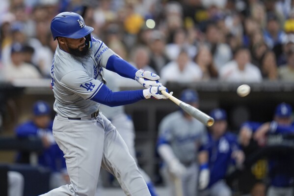 Los Angeles Dodgers' Teoscar Hernandez hits a grand slam during the sixth inning of a baseball game against the San Diego Padres, Saturday, May 11, 2024, in San Diego. (AP Photo/Gregory Bull)