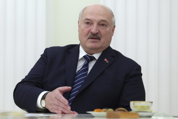 Belarusian President Alexander Lukashenko speaks to the Space crew members of the 21st visiting expedition to the International Space Station (ISS) Roscosmos cosmonaut Oleg Novitsky, left, and the first Belarusian cosmonaut Marina Vasilevskaya during their meeting with Russian President Vladimir Putin, at the Kremlin in Moscow, Russia, Friday, April 12, 2024. (Gavriil Grigorov, Sputnik, Kremlin Pool Photo via AP)