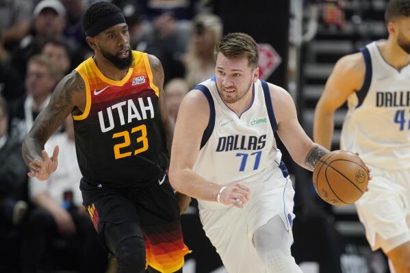 Dallas Mavericks guard Luka Doncic (77) drives past Utah Jazz forward Royce O'Neale (23) in the first in the first half of Game 6 of an NBA basketball first-round playoff series, Thursday, April 28, 2022, in Salt Lake City. (AP Photo/Rick Bowmer)