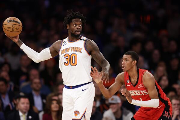New York Knicks forward Julius Randle (30) looks to pass over Houston Rockets forward Jabari Smith Jr. during the first half of an NBA basketball game Monday, March 27, 2023, in New York. (AP Photo/Adam Hunger)