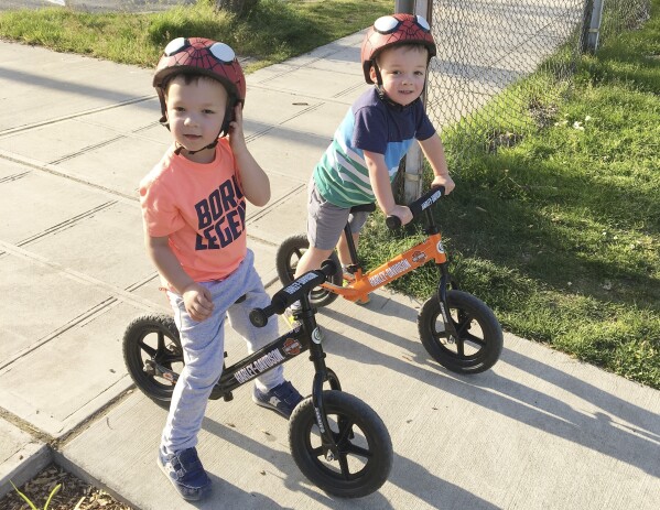 Jackson, left, and Owen Pezalla, both 4, appear on balance bicycles in Seattle on July 1, 2017. Experts recommend starting with those so-called balance bikes at a younger-than-expected age, possibly even less than a year old. (Annie Pezalla via AP)