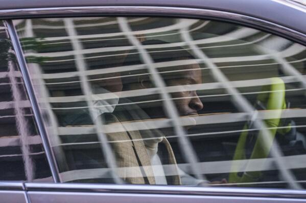 Daystar Peterson, the rap artist known as Tory Lanez, 30, sits in the passenger seat of a sport car as he's driven away from the Clara Shortridge Foltz Criminal Justice Center Tuesday, Dec. 13, 2022, in Los Angeles. Lanez is free on bail after being charged with felony assault for allegedly shooting rapper Megan Thee Stallion in the feet. (AP Photo/Damian Dovarganes)
