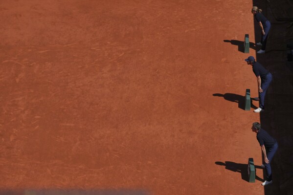 Line judges check the play during the third round match of the French Tennis Open between Denmark's Holger Rune and France's Quentin Halys, at the Roland-Garros stadium, in Paris, Friday, May 30, 2025. (AP Photo/Thibault Camus)