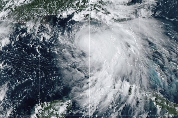 This satellite photo provided by the National Oceanic and Atmospheric Administration shows Tropical Storm Sally, Sunday, Sept. 13, 2020, at 2050 GMT. Sally churned northward on Sunday, poised to turn into a hurricane and send a life-threatening storm surge along the northern Gulf of Mexico. (NOAA via AP)