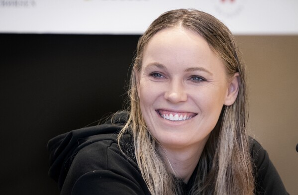 FILE - Caroline Wozniacki, of Denmark, smiles during a press conference in Copenhagen, Denmark, Monday April 4, 2022. Wozniacki, a former No. 1-ranked tennis player and the 2018 Australian Open champion, announced Thursday, June 29, 2023, that she is returning to competition three years after she retired. (Liselotte Sabroe/Ritzau Scanpix via AP, File)