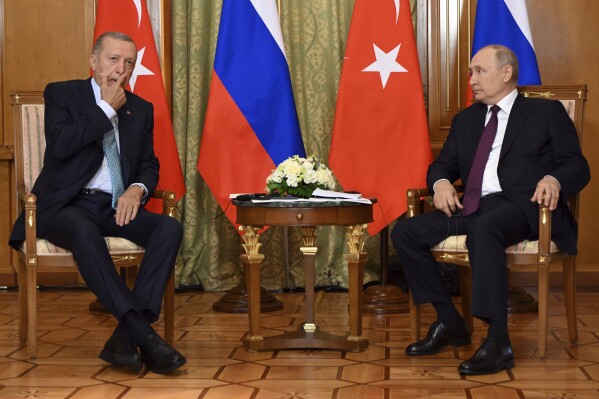 Russian President Vladimir Putin, right, speaks to Turkish President Recep Tayyip Erdogan during their meeting at Russia's Black Sea resort of Sochi, Russia, Monday, Sept. 4, 2023. (Sergei Guneyev, Sputnik, Kremlin Pool Photo via AP)