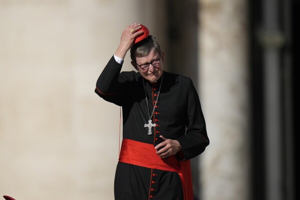 FILE - Cardinal Rainer Maria Woelki attends Pope Francis' weekly general audience in St. Peter's Square at The Vatican, Wednesday, Oct. 5, 2022. German authorities say police and prosecutors have searching Catholic Church properties in connection with a probe of the archbishop of Cologne over perjury allegations. Investigators on Tuesday also searched the premises of an IT company that provides email services to the archdiocese headed by Cardinal Rainer Maria Woelki.(AP Photo/Alessandra Tarantino, File)