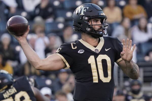 Wake Forest quarterback Sam Hartman (10) looks to pass against Boston College during the second half of an NCAA college football game in Winston-Salem, N.C., Saturday, Oct. 22, 2022. (AP Photo/Chuck Burton)