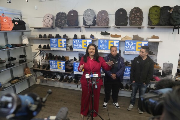 San Francisco Mayor London Breed speaks during a news conference to promote a crime measure at the Footprint retail store as store owner Mike Hsu, right, and police association President Tracy McCray listen, in San Francisco, Thursday, Jan. 25, 2024. The Democratic mayor of San Francisco is pushing a pair of controversial public safety proposals on the March 5, ballot. Critics say the measures are out of step with San Francisco's liberal politics and will hurt already marginalized communities. (AP Photo/Eric Risberg)
