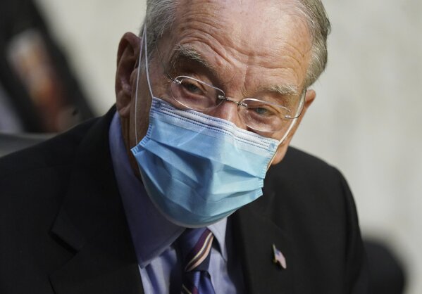 In this Oct. 12, 2020 file photo, Sen. Charles Grassley, R-Iowa, listens during a confirmation hearing for Supreme Court nominee Amy Coney Barrett before the Senate Judiciary Committee, on Capitol Hill in Washington. Grassley, the longest-serving Republican senator, says he is quarantining after being exposed to the coronavirus. Grassley is 87. He did not say how he was exposed. (Kevin Dietsch/Pool via AP)