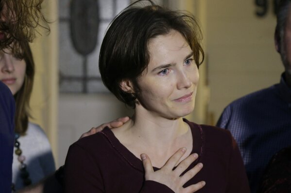 
              In this March 27, 2015 photo Amanda Knox talks to reporters outside her mother's home, in Seattle, WA, United States. Knox says she is returning to Italy for the first time since she was convicted and imprisoned, but ultimately acquitted, for the murder and sexual assault of her British roommate Meredith Kercher in the university hilltop town of Perugia. Knox  on Twitter that “I'm honored to accept their invitation to speak to the Italian people at this historic event and return to Italy for the first time” after she was invited to attend a conference June 14-15 in Modena organized by the Italy Innocence Project, which seeks to help people who have been convicted for crimes they did not commit.  (AP Photo/Ted S. Warren)
            