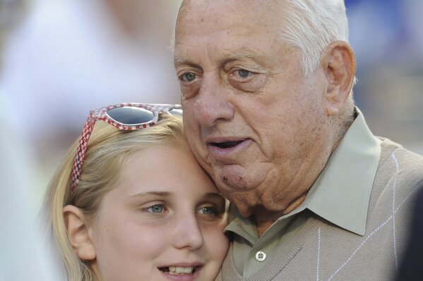 Hall of Fame and former Los Angeles Dodgers manager Tommy Lasorda passed away at the age of 93. Los Angeles Dodgers former manager Tommy Lasorda with owner Mark Walters daughter prior to a baseball game between the San Francisco Giants and the Los Angeles Dodgers on Tuesday, Aug. 22, 2012 in Los Angeles. (Keith Birmingham/The Orange County Register via AP)