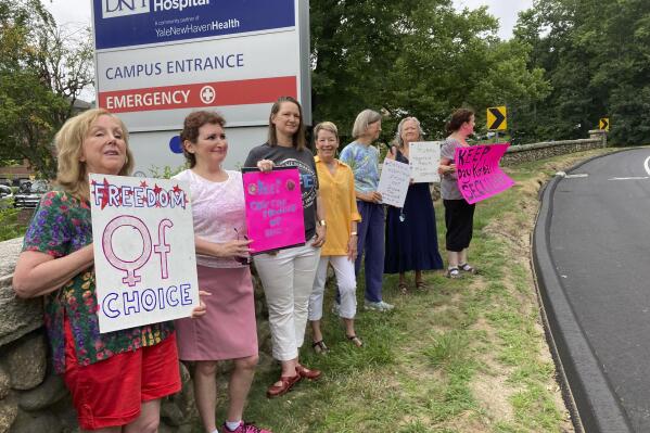 Residents from various communities in mostly rural northeastern Connecticut stage a protest outside Day Kimball Hospital, Monday, July 18, 2022 in Putnam, Conn. The protesters are concerned with Day Kimball Healthcare's plans to affiliate with Covenant Healthcare, a Catholic health system that abides by directives set by the U.S. Conference of Catholic Bishops. (AP Photo/Susan Haigh)