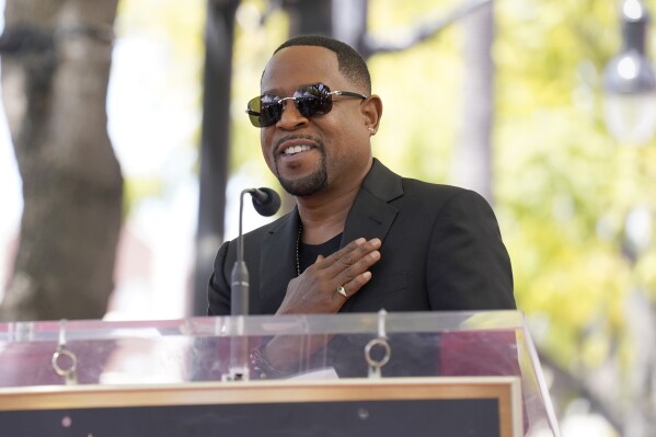 FILE - Martin Lawrence speaks during a star ceremony on the Hollywood Walk of Fame in his honor in Los Angeles on April 20, 2023. Lawrence will star starred alongside Hall of Fame football player Shannon Sharpe in a Super Bowl commercial. (AP Photo/Chris Pizzello, File)
