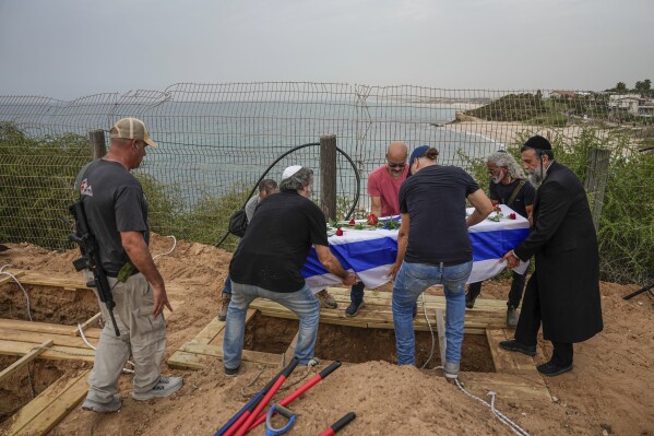 Friends and relatives of Yonat Or carry her coffin during her funeral at Kibbutz Palmachim, Israel, on Sunday, Oct. 29, 2023. Or was killed by Hamas militants on Oct. 7, in Kibbutz Be'eri near the border with the Gaza Strip. More than 1,400 people were killed and some 220 captured in an unprecedented, multi-front attack on Israel by the militant group that rules Gaza. (AP Photo/Ariel Schalit)