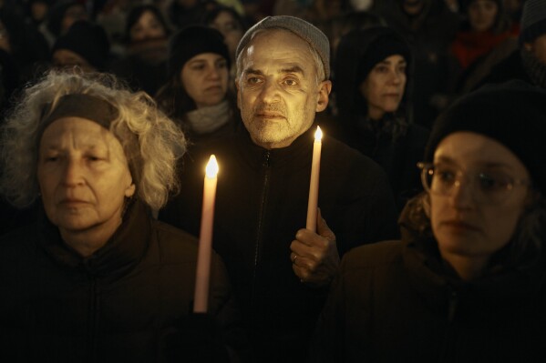 People hold candles as Jewish rabbis and members of the community demand a permanent ceasefire in Gaza during the first night of the Jewish holiday of Hanukkah on Thursday, Dec. 7, 2023, in New York. (AP Photo/Andres Kudacki)