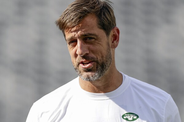 FILE - New York Jets quarterback Aaron Rodgers (8) practices before an NFL preseason football game against the New York Giants, Saturday, Aug. 26, 2023, in East Rutherford, N.J. Rodgers will make his first public media appearance, Friday, Sept. 15, since tearing the Achilles tendon in his left foot four snaps into his debut with his new team Monday night.(AP Photo/Adam Hunger, File)