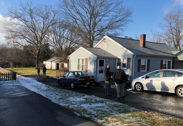 In this Dec. 17, 2020, photo released by Fresno County Sheriff's Office shows the Fauquier County (VA) Sheriff's detectives, agents with Homeland Security Investigations, and the Northern Virginia / District of Columbia Internet Crimes Against Children Task Force searching the house of Nathan Larson in Catlett, Va. Larson, a self-proclaimed pedophile who ran for political office in Virginia was arrested in Denver by investigators who said they stopped him from coaxing a 12-year-old girl to run away from her Fresno, Calif., home and flying with her across the country with intention of having sex with him, authorities announced Saturday, Dec. 19, 2020, Larson, an alleged suspect from Virginia ran for office in the Va. House of Delegates in 2017. (Fresno County Sheriff's Office via AP)