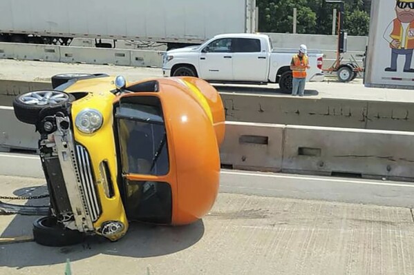 In this photo provided by Chicago Critter, one of Oscar Mayer’s hot dog-shaped Wienermobiles is flipped onto its side after crashing along Interstate 294, a suburban Chicago highway, Monday, July 22, 2024, in Oak Brook, Ill. (Chicago Critter via ĢӰԺ)