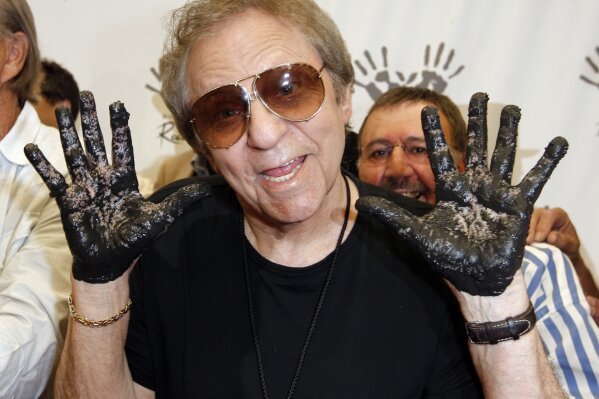 
              FILE - In this June 25, 2008, file photo, Hal Blaine holds up his hands covered in cement after placing them in wet cement with Don Randi and Glen Campbell, representing The Wrecking Crew following an induction ceremony for Hollywood's RockWalk in Los Angeles. Drummer Blaine, who played on many of the biggest hits in music history, has died. Blaine's son-in-law Andy Johnson tells The Associated Press that Blaine died of natural causes Monday, March 11, 2019, at his home in Palm Desert, California. He was 90. (AP Photo/Kevork Djansezian, File)
            