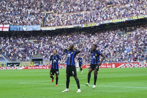 Inter's Marcus Thuram, center, celebrates with teammates after scoring their side's first goal of the Serie A soccer match between FC Inter and ACF Fiorentina, at the San Siro stadium in Milan, Italy, Sunday Sept. 3, 2023. (Spada/LaPresse via AP)