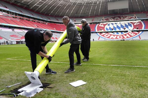 Workers prepare a goal inside the FC Bayern Munich soccer stadium Allianz Arena in Munich, Germany, Wednesday, Nov. 9, 2022. The Tampa Bay Buccaneers are set to play the Seattle Seahawks in an NFL game at the Allianz Arena in Munich on Sunday. (AP Photo/Matthias Schrader)