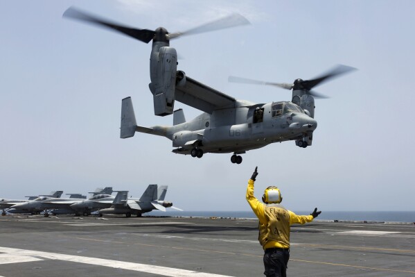 FILE -In this image provided by the U.S. Navy, Aviation Boatswain's Mate 2nd Class Nicholas Hawkins, signals an MV-22 Osprey to land on the flight deck of the USS Abraham Lincoln in the Arabian Sea on May 17, 2019. Air Force Special Operations Command said Tuesday it knows what failed on its CV-22B Osprey leading to a November crash in Japan that killed eight service members. But it still does not know why the failure happened. Because of the crash almost the entire Osprey fleet, hundreds of aircraft across the Air Force, Marine Corps and Navy, has been grounded since Dec. 6. (Mass Communication Specialist 3rd Class Amber Smalley/U.S. Navy via 番茄直播, File)