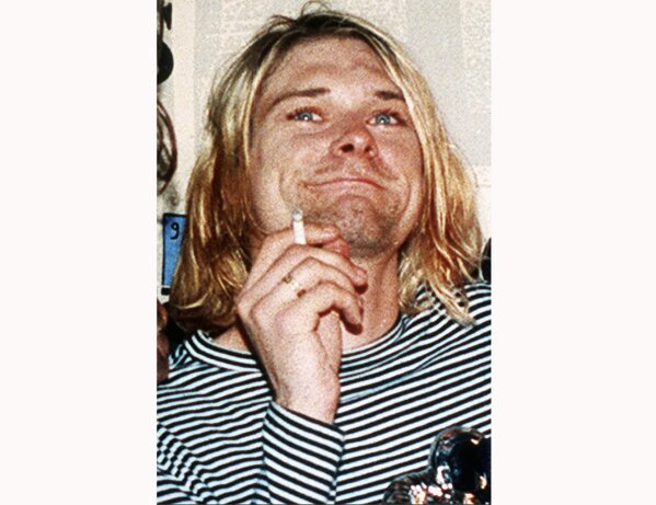 
              FILE - This 1993 file photo shows Kurt Cobain, the lead singer of the US rock band Nirvana. On Friday, April 5, 2019, people gathered throughout the day at Viretta Parkin in Seattle, leaving flowers, candles and written messages on the 25th anniversary of Cobain's death. Cobain, whose band Nirvana rose to global fame amid Seattle's grunge rock years of the early 1990s, shot himself on April 5, 1994 in his home near Lake Washington. (AP Photo/Mark J.Terrill, File)
            