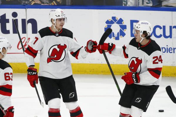 New Jersey Devils center Yegor Sharangovich (17) celebrates his goal with defenseman Ty Smith (24) during the third period of an NHL hockey game against the Buffalo Sabres, Wednesday, Dec. 29, 2021, in Buffalo, N.Y. (AP Photo/Jeffrey T. Barnes)