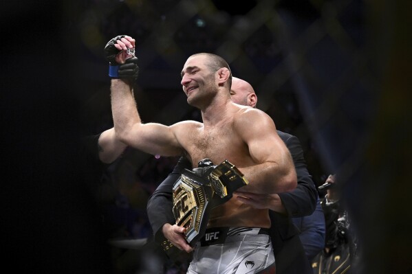 American Sean Strickland celebrates defeating Nigerian-born New Zealander Israel Adesanya to claim the middleweight title by unanimous decision in the main event of UFC 293 in Sydney, Sunday, Sept. 10, 2023. (Dan Himbrechts/AAP Image via AP)