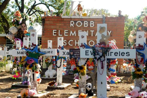 A memorial for the 19 children and two teachers killed in the May shooting sits outside of Robb Elementary on the first day of early voting, Monday, Oct. 24, 2022, in Uvalde, Texas.  The Uvalde school massacre has cast a long shadow in the midterm elections in Texas, intensifying Republican Gov. Greg Abbott’s reelection fight against Democrat Beto O’Rourke and driving a blitz of television ads. (AP Photo/Acacia Coronado)