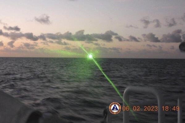FILE - This photo provided by the Philippine Coast Guard shows a green military-grade laser light from a Chinese coast guard ship in the disputed South China Sea on Feb. 6, 2023. The Philippine coast guard has launched a strategy of publicizing aggressive actions by China in the disputed South China Sea, which has countered Chinese propaganda and sparked international condemnation that has put Beijing under the spotlight, a Philippine official said Wednesday, March 8. (Philippine Coast Guard via AP)