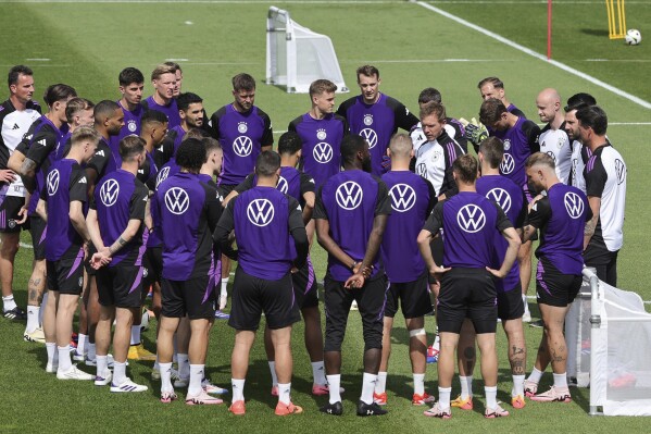 Germany national team, players and coaches stand together in a circle during a public training in Herzogenaurach, Germany, Monday June 10, 2024. (Christian Charisius/dpa via AP)