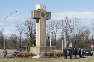 FILE - In this Feb. 13, 2019 file photo, visitors walk around the 40-foot Maryland Peace Cross dedicated to World War I soldiers in Bladensburg, Md. The Supreme Court says the World War I memorial in the shape of a 40-foot-tall cross can continue to stand on public land in Maryland. The high court on Thursday rejected a challenge to the nearly 100-year-old memorial. The justices ruled that its presence on public land doesn’t violate the First Amendment’s establishment clause. That clause prohibits the government from favoring one religion over others.(AP Photo/Kevin Wolf)