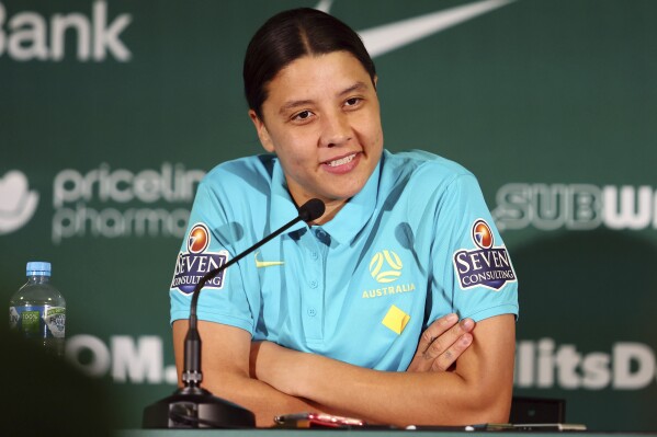 Australia's Women's World Cup captain Sam Kerr reacts during a press conference in Brisbane, Australia, Saturday, July 29, 2023. Kerr says she'll be available for Australia's must-win Women's World Cup game against Olympic champion Canada after missing the team's first two group games because of a calf muscle injury. (AP Photo/Tertius Pickard)