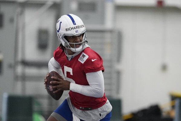 FILE - Indianapolis Colts quarterback Anthony Richardson participates in a drill during NFL football practice, Tuesday, June 13, 2023, in Indianapolis. The Indianapolis Colts will start this season with another new quarterback behind center. The big question is who will it be? After parting ways with veterans Matt Ryan and Nick Foles after one season, the Colts signed former NFL starter Gardner Minshew and drafted Richardson with the fourth overall pick. (AP Photo/Darron Cummings, File)