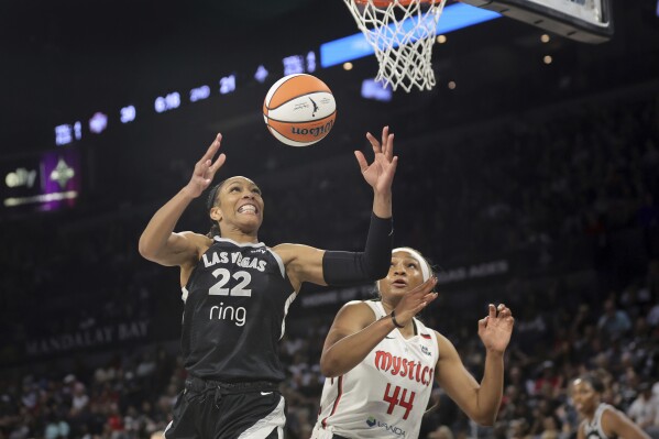 Las Vegas Aces center A'ja Wilson (22) and Washington Mystics forward Kiki Iriafen (44) go after a rebound during the first half of a WNBA basketball game Friday, May 23, 2025, in Las Vegas. (Steve Marcus/Las Vegas Sun via AP)