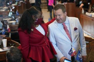 FILE - In this April 12, 2021 file photo, Sen. Katrina Jackson, D-Monroe, talks with Stuart Bishop, R-Lafayette, chairman of the House Ways and Means Committee, during opening day of the Louisiana legislative session in Baton Rouge, La. Republican House leaders planned to try again Thursday, May 20 to pass a complicated income tax swap that is the centerpiece of a bid to overhaul Louisiana’s tax structure, hoping to salvage the effort as time runs short in the legislative session.  (AP Photo/Gerald Herbert, File)