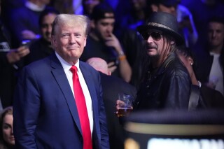 Former President Donald Trump, left, stands with Kid Rock at the UFC 295 mixed martial arts event Saturday, Nov. 11, 2023, in New York. Social media users are falsely claiming Kid Rock and fellow performer Jason Aldean canceled New York shows in response to a ruling against Trump. (AP Photo/Frank Franklin II)