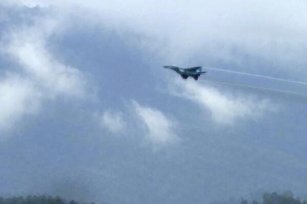 In this image taken from video, a fighter jet flies overhead and visible from Tak province, Thailand on Thursday, June 30, 2022. A Myanmar fighter jet crossed the border into Thailand's airspace, prompting Thai air force jets to scramble and officials to order the evacuation of villages and classrooms, officials said. (AP Photo/Chiravut Rungjumrusrussamee)