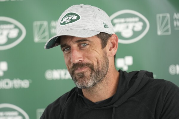 New York Jets quarterback Aaron Rodgers talks to reporters after a joint practice with the Tampa Bay Buccaneers at the Jets' training facility in Florham Park, N.J., Wednesday, Aug. 16, 2023. (AP Photo/Seth Wenig)
