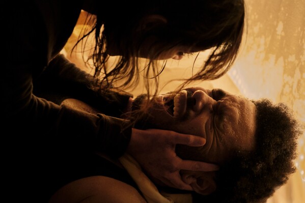 This image released by Lionsgate shows Jenna Ortega as Anima, top, and Abel "The Weeknd" Tesfaye as Abel, in a scene from "Hurry Up Tomorrow." (Andrew Cooper/Lionsgate via AP)