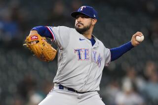 FILE - Texas Rangers starting pitcher Martin Perez throws against the Seattle Mariners during the first inning of a baseball game, Wednesday, Sept. 28, 2022, in Seattle. All-Star left-hander Martin Pérez accepted a $19.65 million qualifying offer from the Texas Rangers before the deadline on Tuesday, Nov. 15, 2022. (AP Photo/Caean Couto, File)