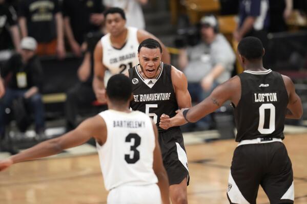 St. Bonaventure guard Jaren Holmes, left center, celebrates with guard Kyle Lofton, right, after hitting a pair of free throws, as Colorado guard Keeshawn Barthelemy, front, and forward Evan Battey watch late in the second half of an NCAA college basketball game in the first round of the NIT on Tuesday, March 15, 2022, in Boulder, Colo. (AP Photo/David Zalubowski)