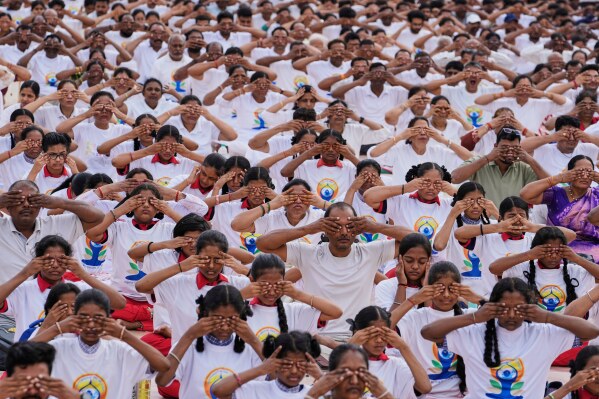 People practice yoga on the eve of International Day of Yoga at Lal Bahadur stadium in Hyderabad, India, Friday, June 20, 2025. (AP Photo/Mahesh Kumar A.)