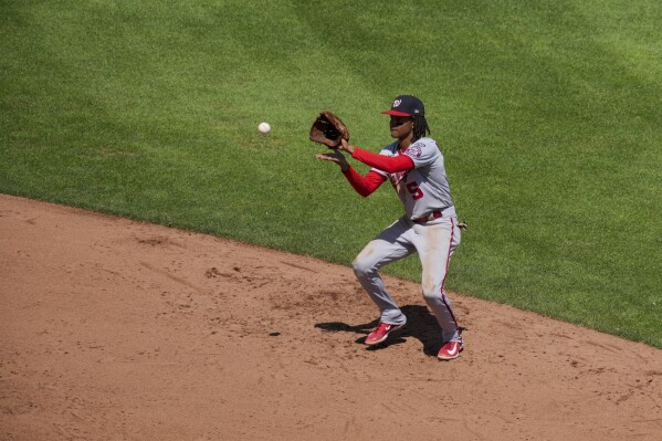 CJ Abrams of the Washington Nationals throws the ball to first