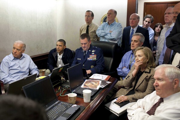 FILE -In this image released by the White House and digitally altered by the source to diffuse the paper in front of Secretary of State Hillary Clinton, President Barack Obama and Vice President Joe Biden, along with with members of the national security team, receive an update on the mission against Osama bin Laden in the Situation Room of the White House in Washington, on May 1, 2011. (AP Photo/The White House, Pete Souza, File)