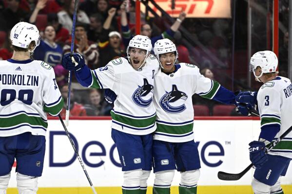 Vancouver Canucks center Bo Horvat (53) celebrates his goal against the Ottawa Senators during the first period of an NHL hockey game, Tuesday, Nov. 8, 2022 in Ottawa, Ontario. (Justin Tang/The Canadian Press via AP)