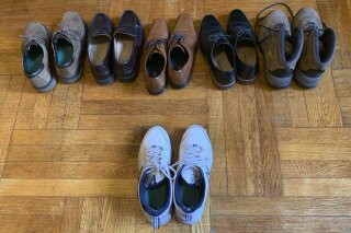 Associated Press journalist Dave Clark displays the six pairs of shoes he owns in his apartment in Manhattan’s Washington Heights neighborhood Wednesday, July 22, 2020, in New York, with the one pair he’s worn since lockdown, caused by the coronavirus pandemic, began. (AP Photo/Dave Clark)